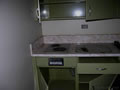 The faculty break room was complete with a two heating element stove and avocado green cabinets.